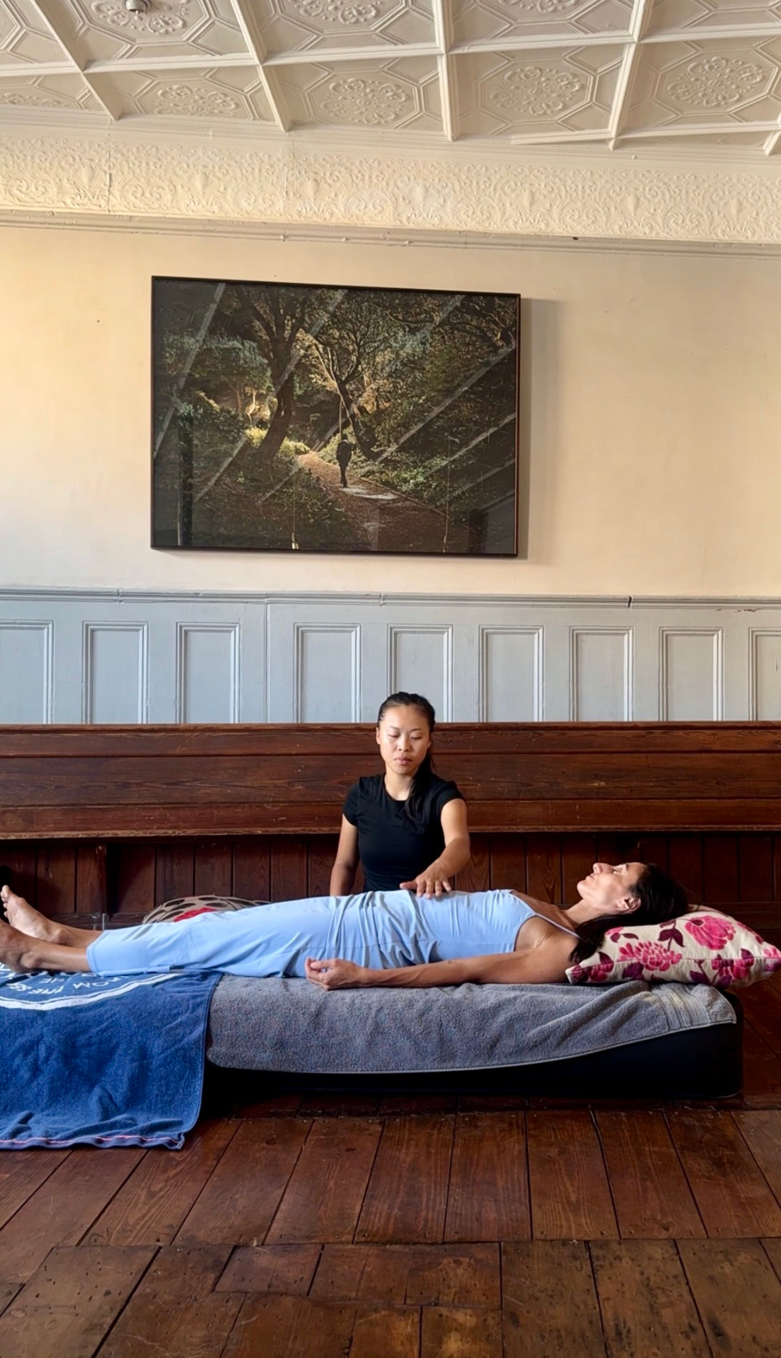 Caryn giving an energy healing session in a light-filled London room